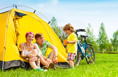 Young family enjoying a bicycle and camping holiday